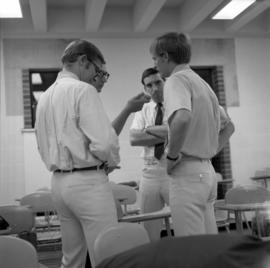 John Denver, Mike Kobluk, and David Boise of the Mitchell Trio are interviewed by WJON's Mike Diem before their concert at Halenbeck Hall (1966), St. Cloud State University