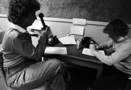 Two women answer phones in the KVSC studios during KVSC trivia weekend