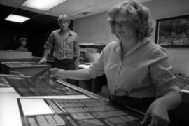 Student Mari Adamson examines a newspaper layout at a Mass Communication workshop, St. Cloud State University