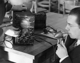 LeRoy Hoff speaks into a radio, St. Cloud State University