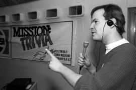 Student Bill Devine speaks into a microphone, KVSC trivia weekend, St. Cloud State University