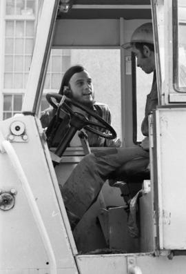 A protestor talks to a construction worker, Day of Peace protest, St. Cloud State University