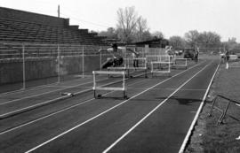 Sue Wahl practices jumping hurdles during track practice at Selke Field (1937), St. Cloud State University