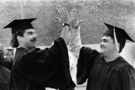 Two graduates celebrate at commencement, St. Cloud State University