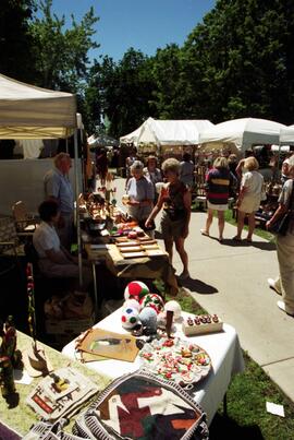 People gather on sidewalks to visit vendors' booths, Lemonade Concert and Art Fair, St. Cloud State University