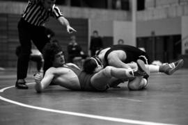 St. Cloud State wrestler Dennis Stoks takes down University of Wisconsin-River Falls wrestler Terry Geibel during a match