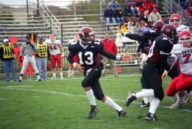 Quarterback Keith Heckendorn hands off the ball against the University of South Dakota, St. Cloud State University