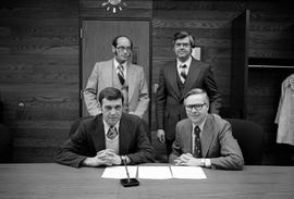 Fran Voelker, Art Grachek, Doug Johnson, and Charles Graham sign an agreement to deposit records of the Inter-Faculty Organization and the Faculty Association at the St. Cloud State University Archives