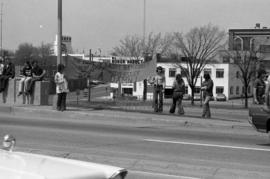 Protestors hold a sign to passing car traffic, Day of Peace protest, St. Cloud State University