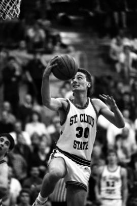 Basketball player Kevin Skarich makes a lay up during a game against Moorhead State University, St. Cloud State University