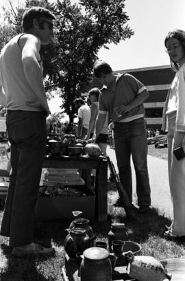 People examine pottery, Lemonade Concert and Art Fair, St. Cloud State University