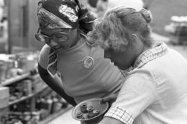 Two women check out merchandise, Lemonade Fair, St. Cloud State University