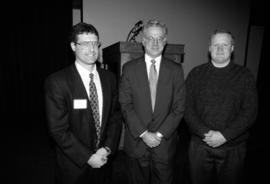 Mark Partridge, Chris Farrell, and Kevin M. Murphy stand together at the Winter Institute event, St. Cloud State University