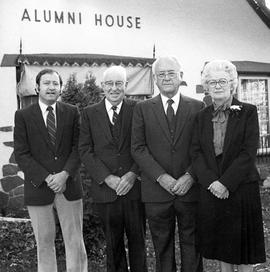 Stephen Wenzel, Clair Daggett, Robert Wick, and Alice Wick stand in front of the Alumni House (1973), St. Cloud State University