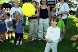 A girls gets ready to hit a pinata, Lemonade Concert and Art Fair, St. Cloud State University