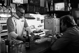 Bartender Darrell Peterson plays cribbage with customer Mark Fitzharris at the Flat Iron Bar, St. Cloud