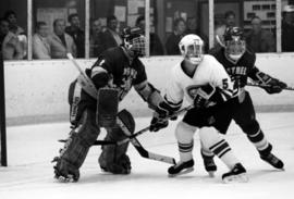 Three hockey players stand in front of the net, St. Cloud State University