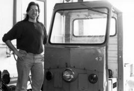 Dan Michaels stands next to a Cushman cart, St. Cloud State University