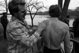 Curt Quiner is greased up before swimming across the Mississippi River, St. Cloud State University