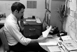 Doug Johnson sits at a desk, St. Cloud State University