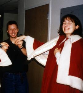 University Program Board (UPB) student Matt Trombley and another person try on homecoming cape, St. Cloud State