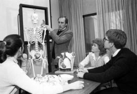 A man uses a skeleton to teach, Speech Pathology, St. Cloud State University