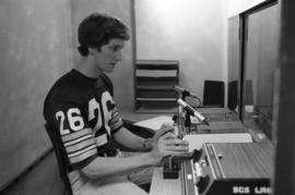 A man sits in front of equipment, Speech Pathology, St. Cloud State University