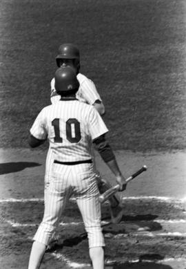 Jim Eisenreich greets Paul Thielen at home plate during a St. Cloud State University baseball game against the University of Minnesota-Duluth