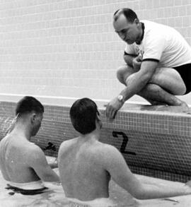 Swim coach Rufus Wilson assists swimmers, St. Cloud State University
