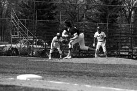 Bob Hegman and Denny Lorsung watch an opposing player pitch a baseball during a St. Cloud State University baseball game against the University of Minnesota-Duluth