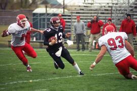 Quarterback Keith Heckendorn runs with the ball against the University of South Dakota, St. Cloud State University