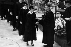 President Robert Wick hands out diplomas during commencement