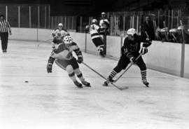 St. Cloud State hockey player Pat Sullivan chases after the puck against Chicago State in men's hockey