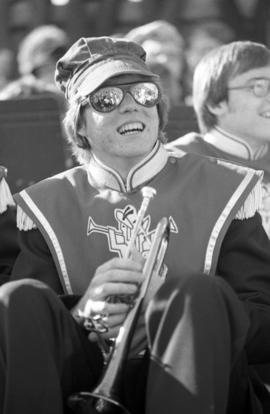 Marching band member holds a trumpet during the homecoming football game, St. Cloud State University