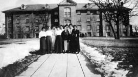 Women stand in front of Lawrence Hall (1905), St. Cloud State University