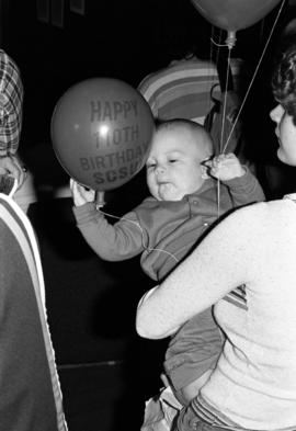 Baby holds a balloon during the 110th anniversary celebration of the establishment of St. Cloud State University