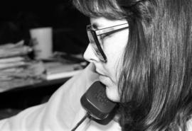 A woman talks on a telephone, KVSC trivia weekend, St. Cloud State University