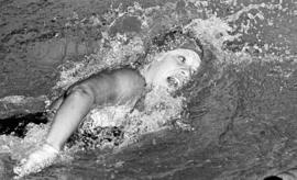 St. Cloud State University swimmer Kathy Smith competes against Carleton College