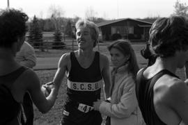 St. Cloud State cross country runner Scott Ergen congratulates another runner after a race