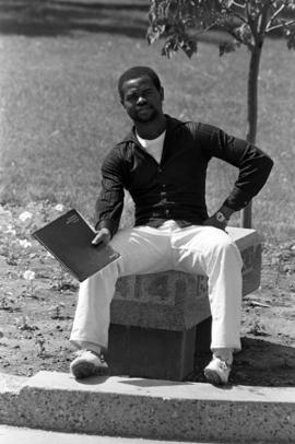 Student sits on a bench, St. Cloud State University