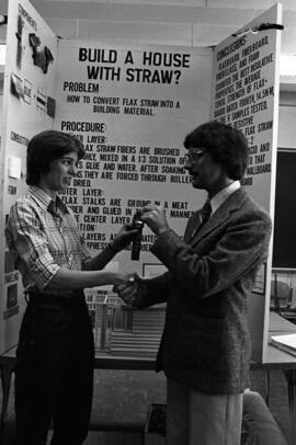 Woman receives a ribbon at the science fair, St. Cloud State University