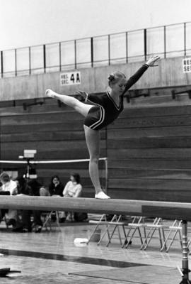 Gymnast Kristin Winter balances on a balance beam in a meet against Augsburg College, St. Cloud State University