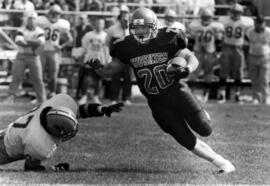 Randy Martin runs with a football during a game, St. Cloud State University