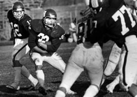 St. Cloud State University football player Terry Kearney get the ball from quarterback Tom Nelson against Winona State University