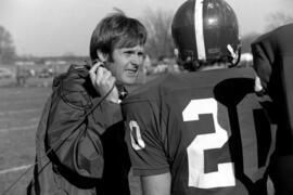 Head football coach Mike Simpson talks to a player during a St. Cloud State Unviersity football game against Moorhead State University