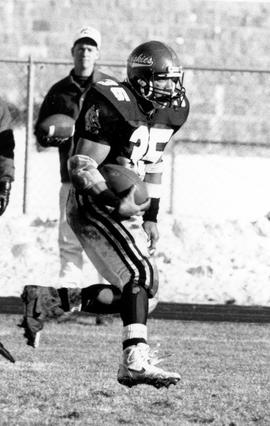 Football player Harry Jackson runs with the football, St. Cloud State University