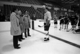 A hockey player talks to William Radovich, David Sprague, and Steve Ludwig at the National Hockey Center (1989), St. Cloud State University