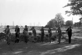 People shovel dirt at the National Hockey Center (1989) groundbreaking, St. Cloud State University