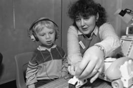 A woman works with a child, Speech Pathology, St. Cloud State University