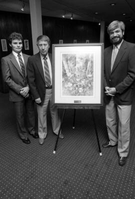 Former Atwood Memorial Center director Joe Basil accepts a painting from the family of Janelle Johnson, St. Cloud State University